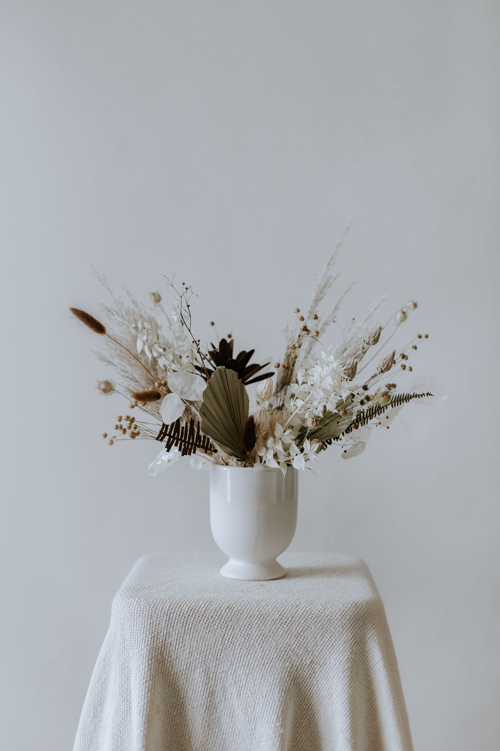 Small Everlasting Arrangement in Vintage - Timeless dried flowers in nostalgic hues presented in a doll white porcelain vase.