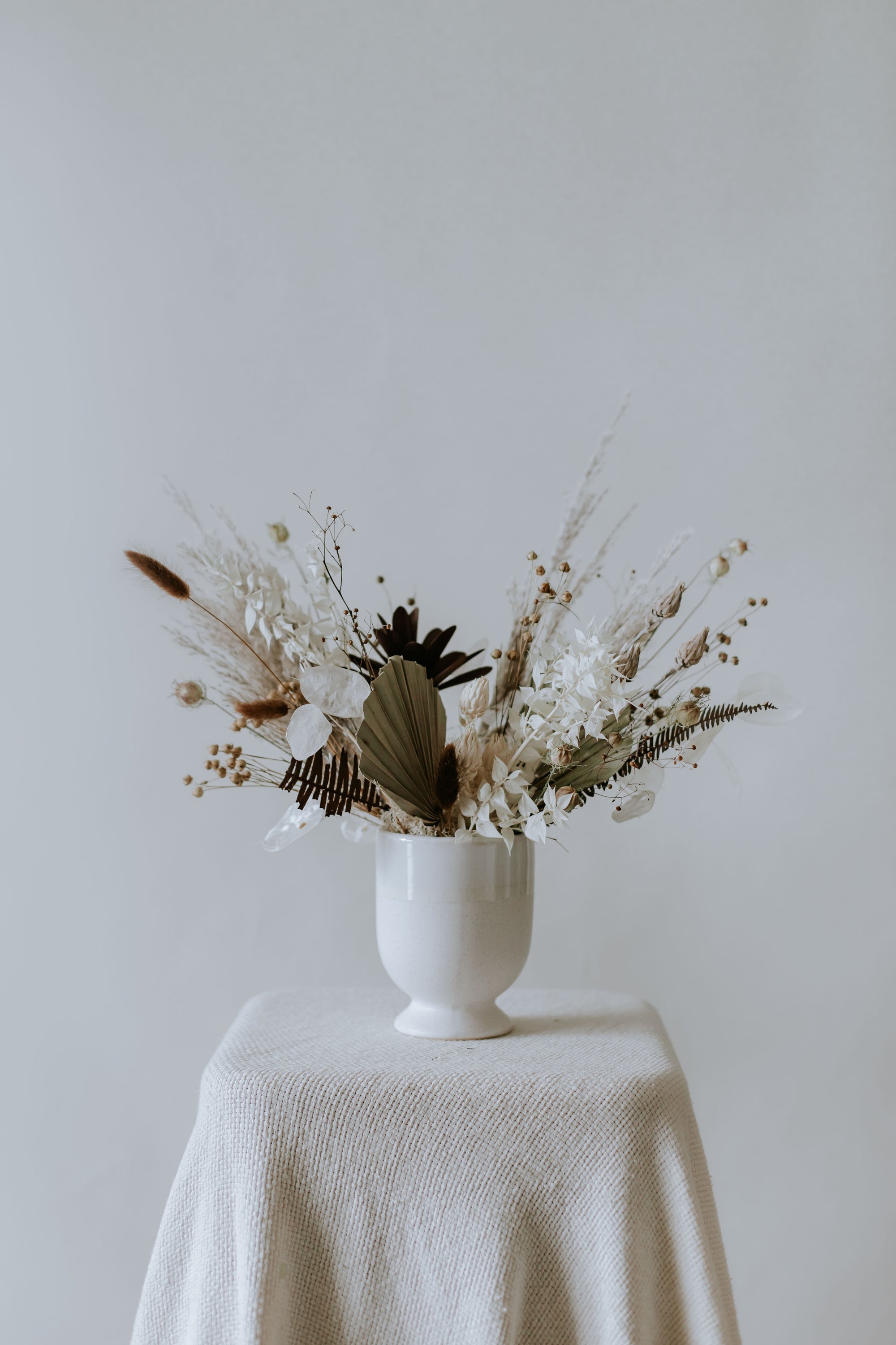 Small Everlasting Arrangement in Vintage - Timeless dried flowers in nostalgic hues presented in a doll white porcelain vase.