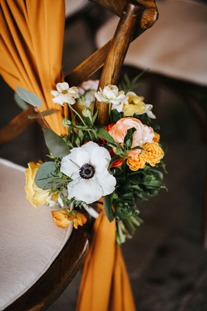 Elegant pew flower, infusing Toronto wedding aisles with the sunny brilliance and warmth reminiscent of the beautiful Sunshine Coast