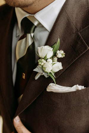 Elegant boutonnière from the Forest Wonderland Collection, capturing the essence of woodland charm with a delicate bloom.